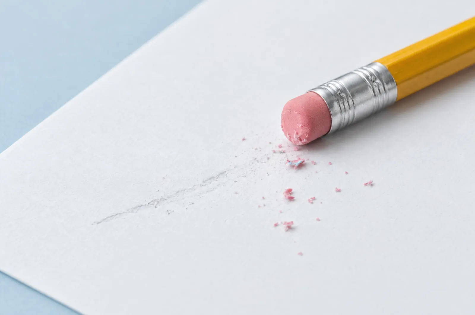 A pencil eraser beside a faint erased line on white paper